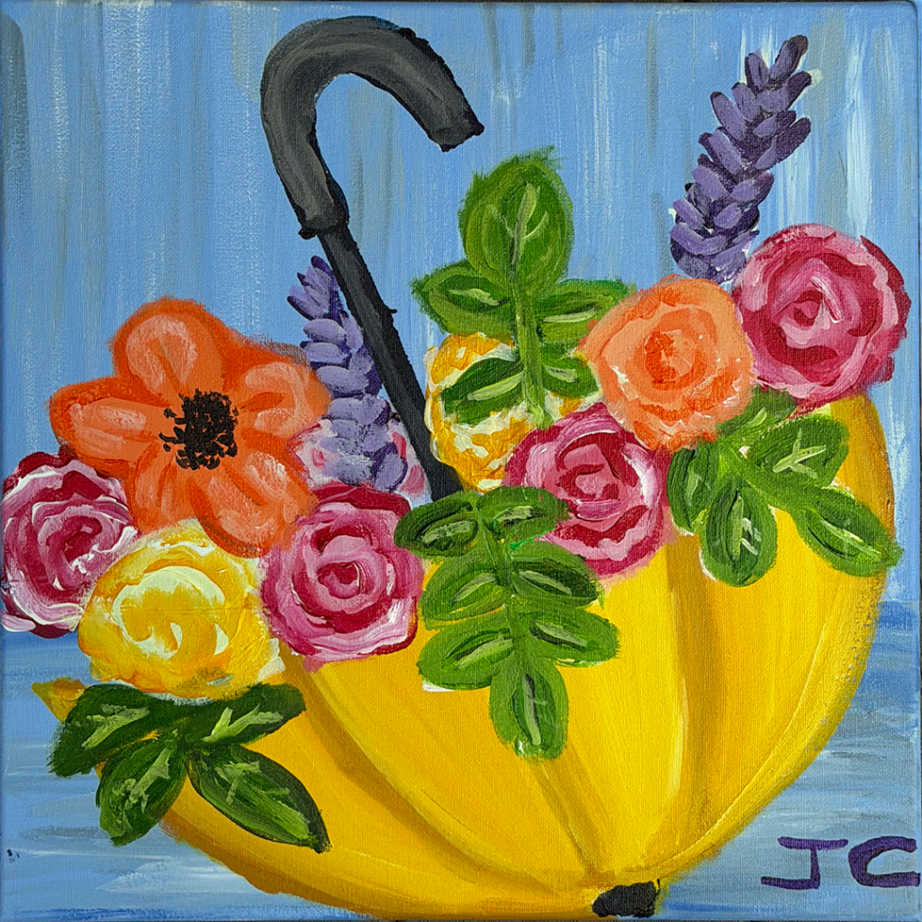 Multicolored flowers overflowing upside down yellow umbrella