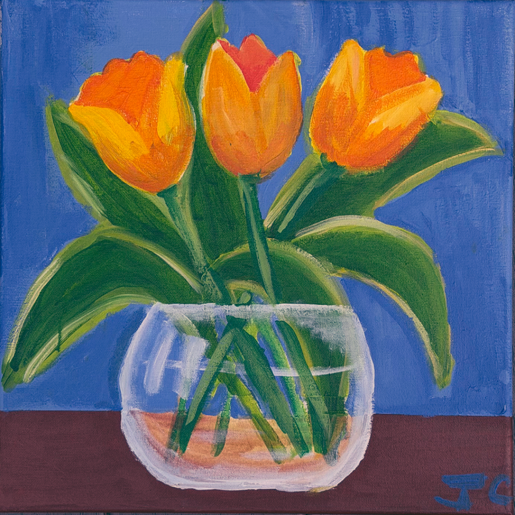 Orange flowers in clear vase